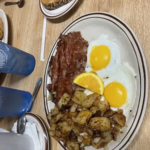 Corn beef hash , potatoes with onions, sunny side eggs, home made toast