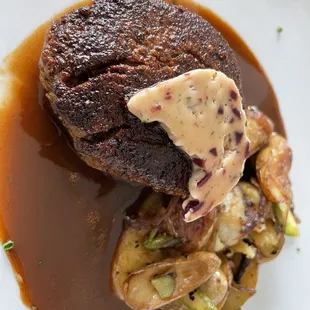 a steak with mushrooms and gravy