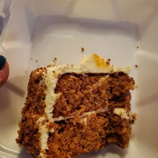 a piece of carrot cake in a styrofoam container