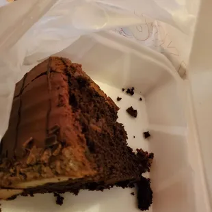 a piece of chocolate cake in a styrofoam container