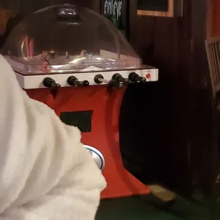 a red stove with a glass dome on top