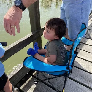 Lil man just watching. He wasn't big enough yet to hold his own pole.