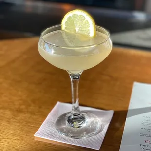 a cocktail with a slice of lemon