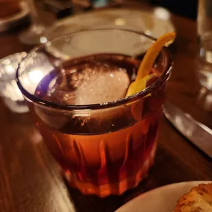 a glass of tea with a slice of lemon