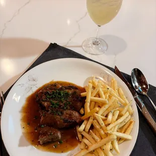 a plate of steak and french fries