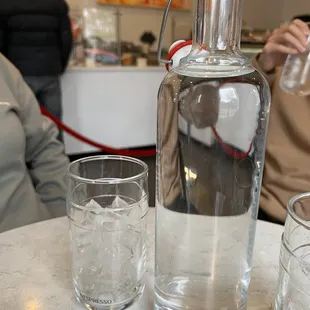 a glass of water and a decanter