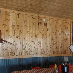 Local ranches come and brand the wall in the eating area