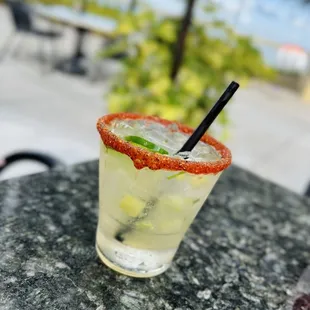 a margarita with a garnish on the rim