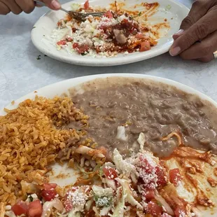 Enchiladas roja (red) with rice and beans.