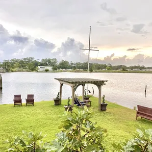Looking down from the back porch at the gazebo / porch swing with a summer storm on the horizon.