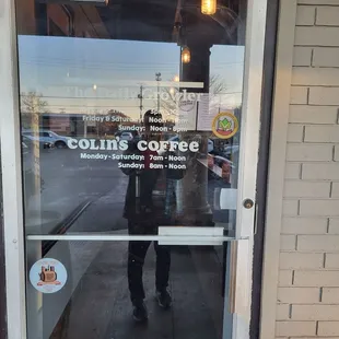 a man standing in front of a coffee shop