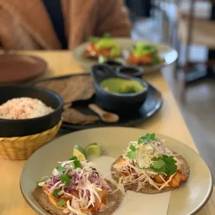 From front to back: shrimp tacos, corn elote, masa chips, chicken tinga tostadas