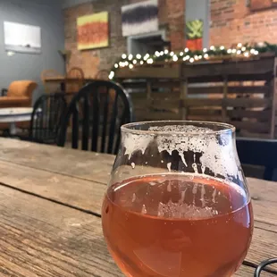 a glass of coffee on a wooden table