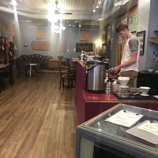 a man preparing coffee in a coffee shop