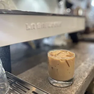 a glass of iced coffee on a counter
