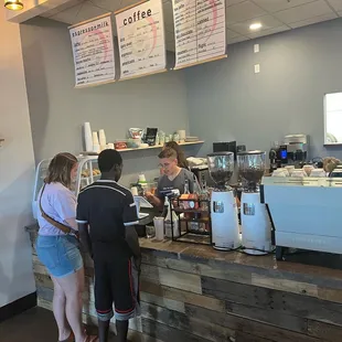 customers at the counter of a coffee shop
