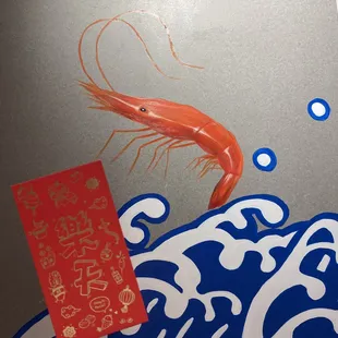 a shrimp and a red packet