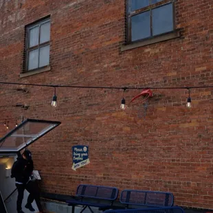 a man walking past a brick building