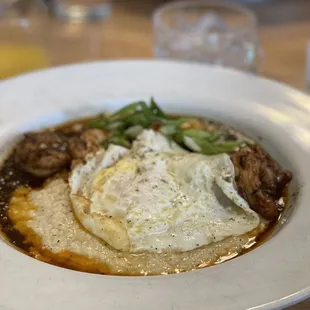 Shrimp and grits with added over easy egg for an additional $2
