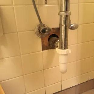 Hole in bathroom wall tile. Very professional!