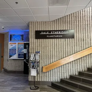 Entrance is behind the staircase.