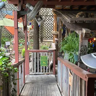 a porch with a grill and chairs