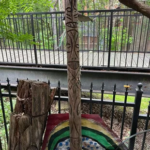 a wooden pole with a rainbow painted on it