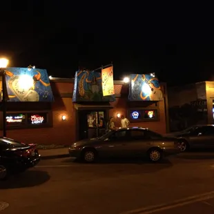 cars parked in front of a sports bar