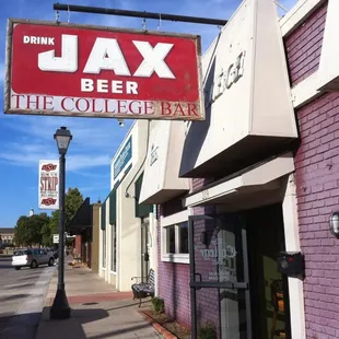 a red and white sign for jax beer