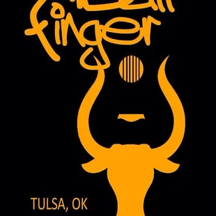 a bull with a guitar in the background