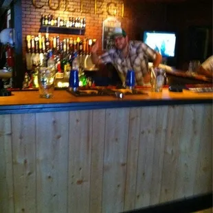 a man behind the bar at a bar