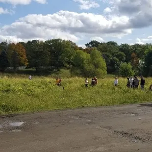 a group of people walking down a dirt road