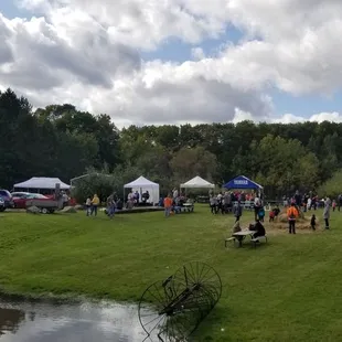 a group of people walking around a pond