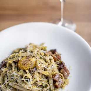 a plate of pasta and a glass of wine