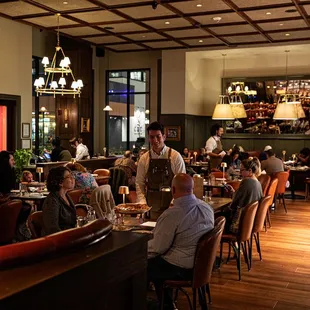 people sitting at tables in a restaurant