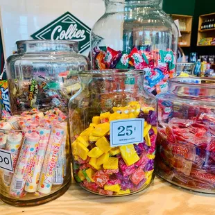 a variety of candy in glass jars