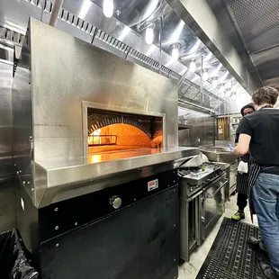 a man standing in front of an oven