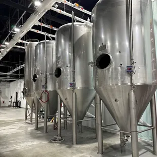a row of stainless steel tanks