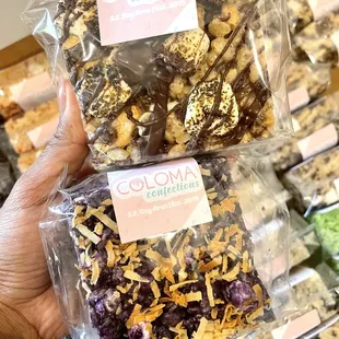 a hand holding a bag of chocolate