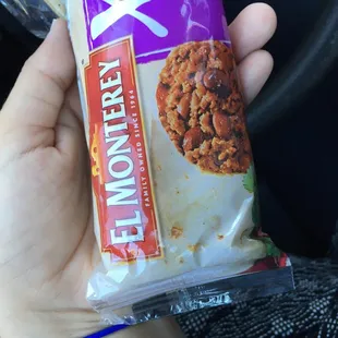 a hand holding a bag of cereal