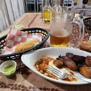 a plate of food and a glass of beer