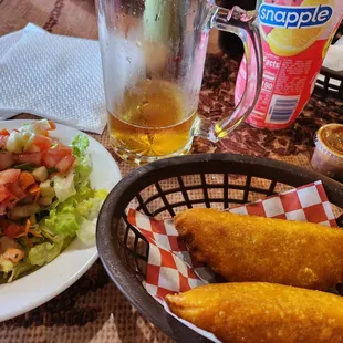 a plate of food and a glass of beer
