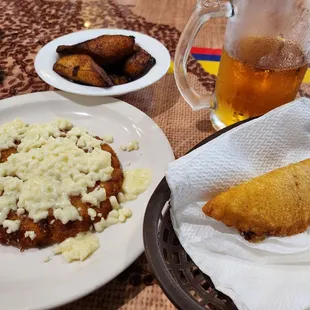 a plate of food and a glass of beer
