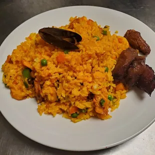 Valencian Rice (Similar Spanish paella). Rice in saffron Latin style mix with seafood, chicken, pork sausage and other