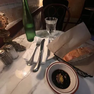 table setting with bread, soup, and wine