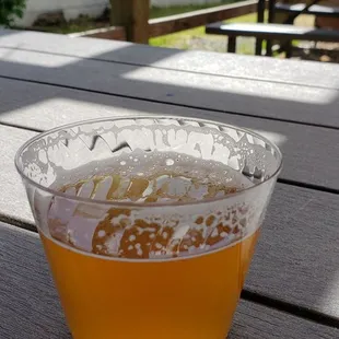 a glass of beer on a picnic table