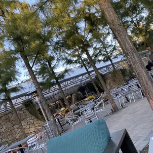 an outdoor seating area with tables and chairs