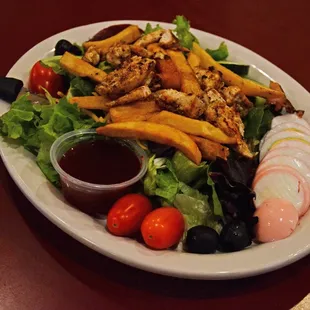 a plate of french fries and salad