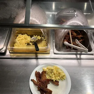 a plate of bacon, eggs, and hash browns