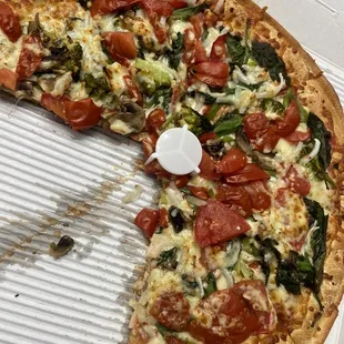 a half eaten pizza in a box